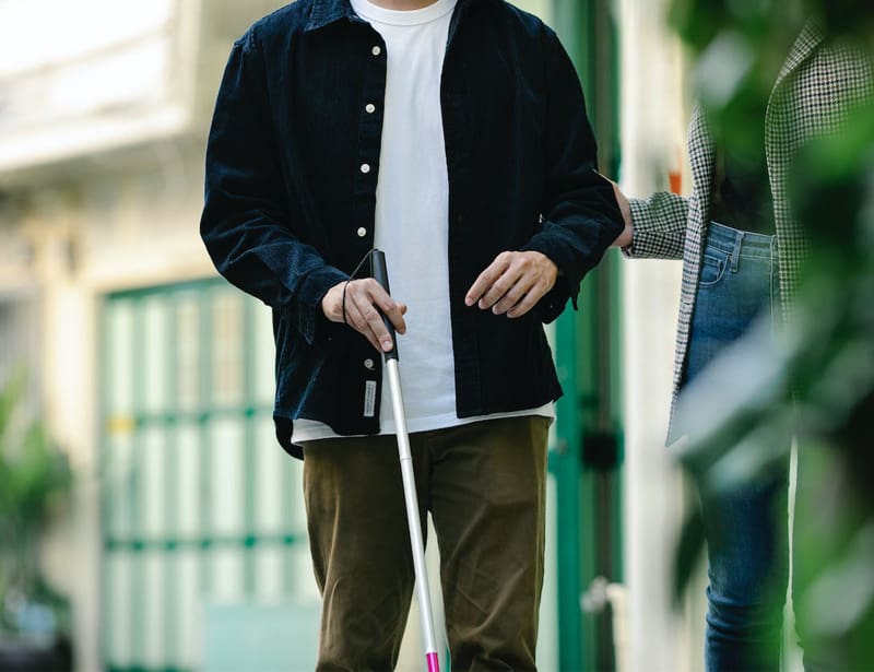 man holding a walking stick