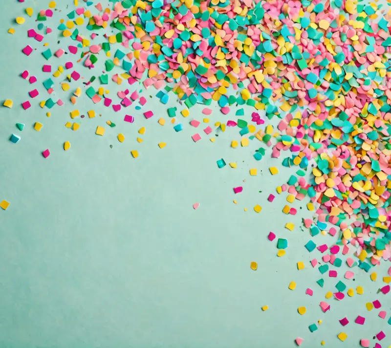 Colorful confetti burst against pastel background