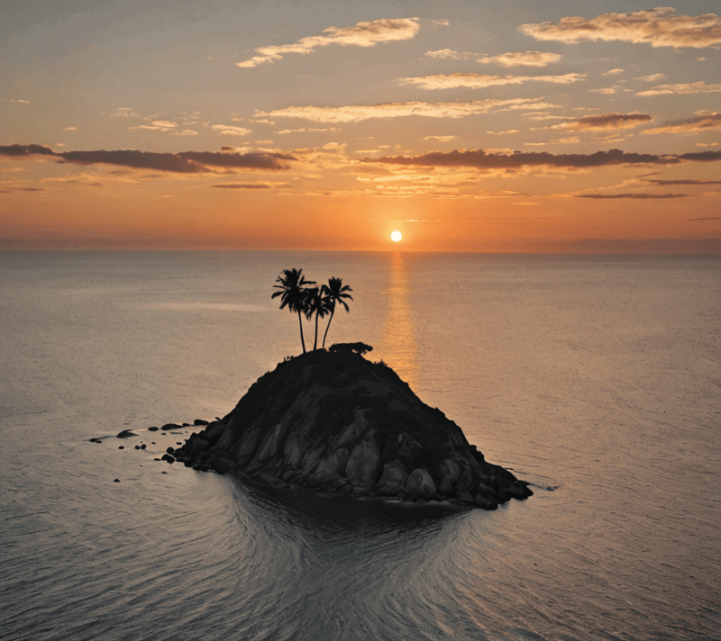 Lone island in a vast ocean during magic hour with a single palm tree.