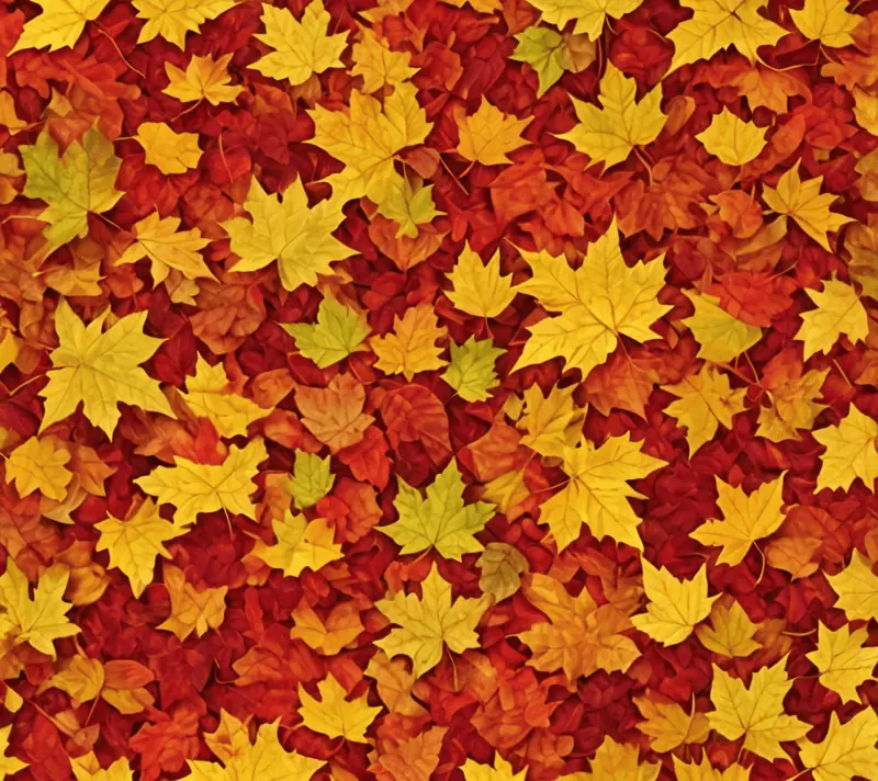 Carpet of autumn leaves with a gradient from reds to yellows
