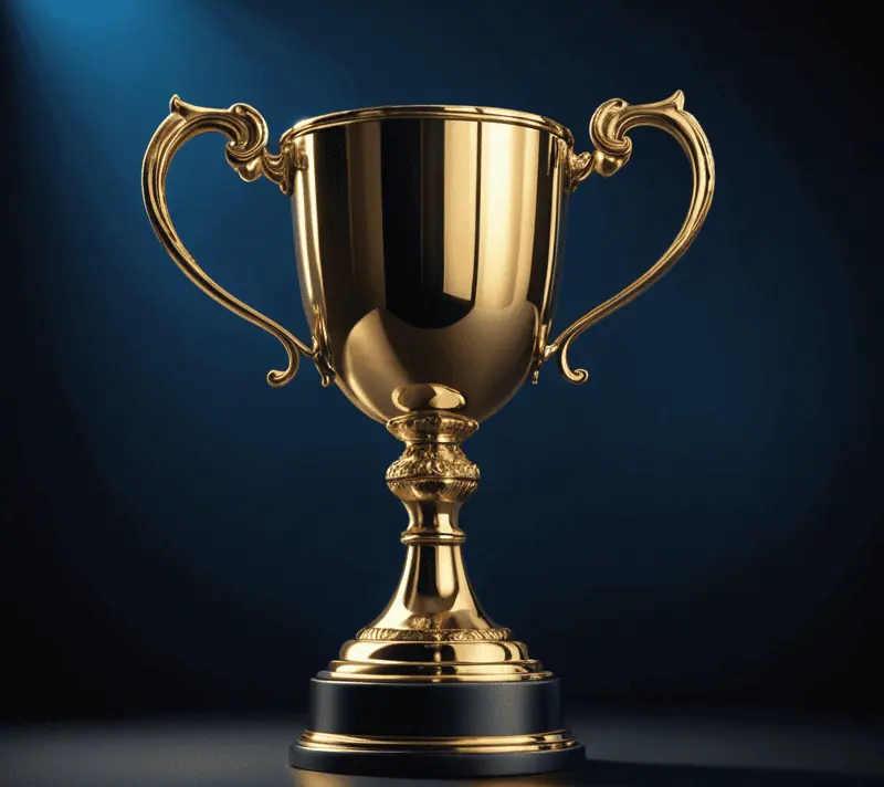 Golden trophy cup illuminated by a spotlight against a deep blue velvet background
