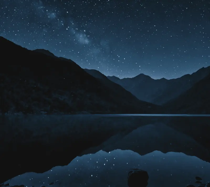 A serene moonlit lake with twinkling stars and a firefly, surrounded by mountain silhouettes at night.