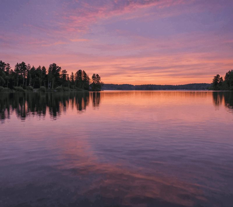 A serene twilight lake with ripples from a bird's takeoff, embodying resonance.
