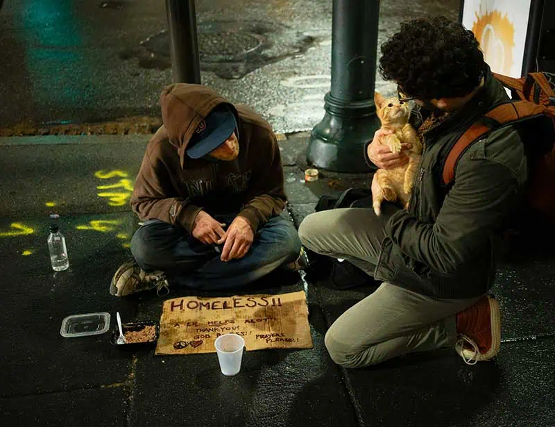 A compassionate man talking to a homeless person