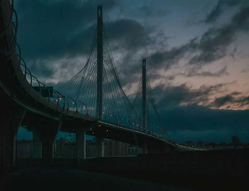 Bridge at night with dramatic sky.