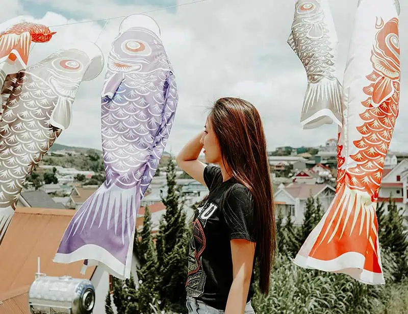 a woman daydreaming amongst fish flags