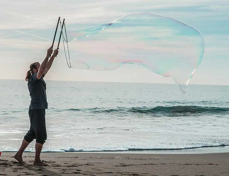 a skilled balloonist at the beach