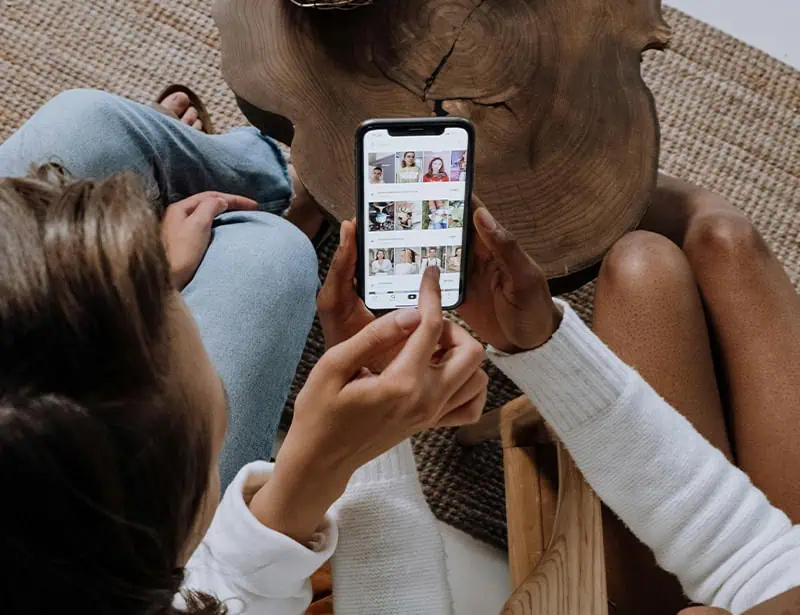 two people scrolling phone