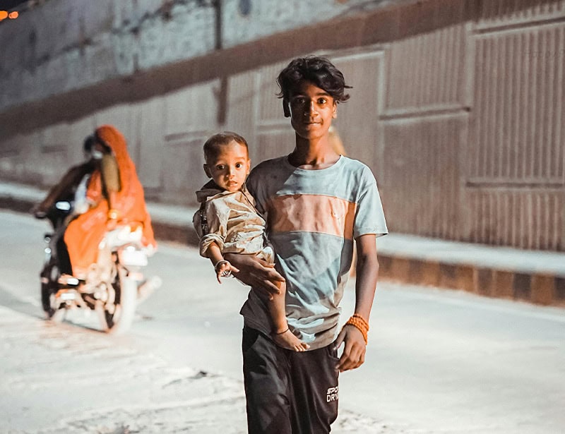 teenager and baby in the street