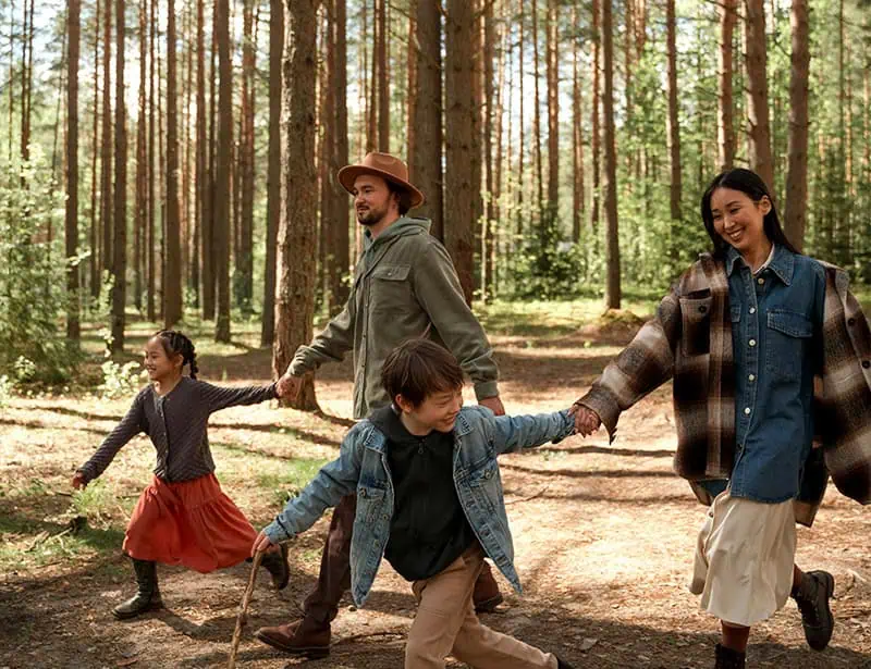diverse family walking in forest