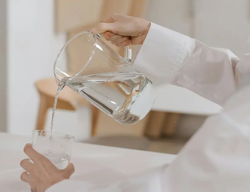 pouring water on glass