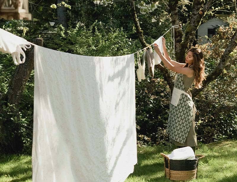woman hanging laundry outside