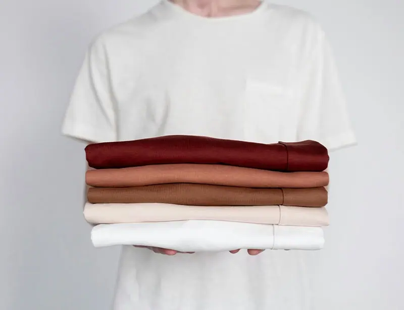 person carrying folded garments