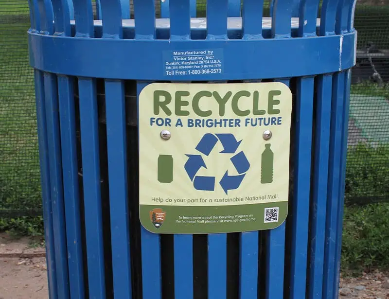 blue recycling bin with sign