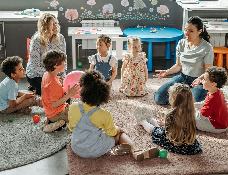 children and two teachers in kindergarten class
