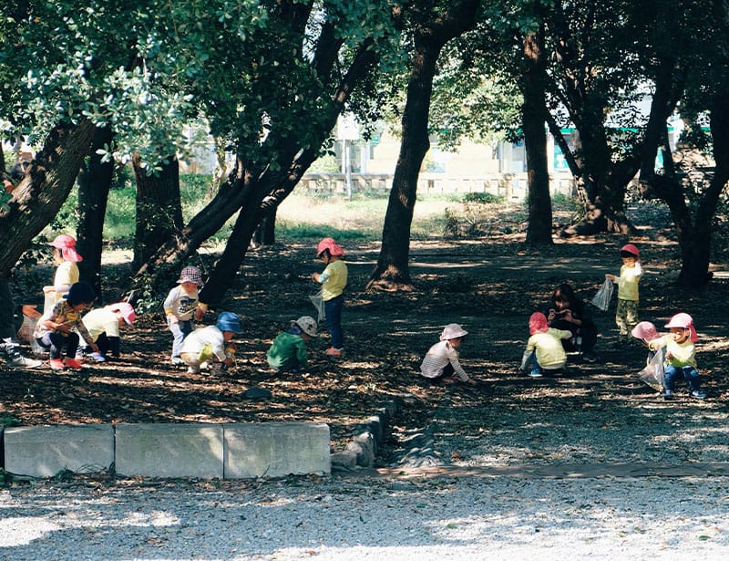 kindergarten students having a class outdoors