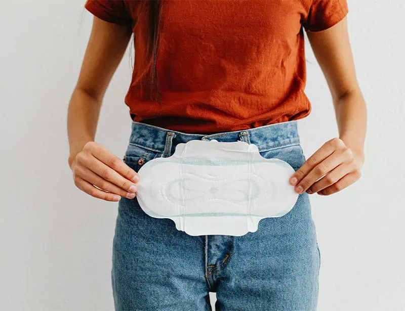 woman holding period pad