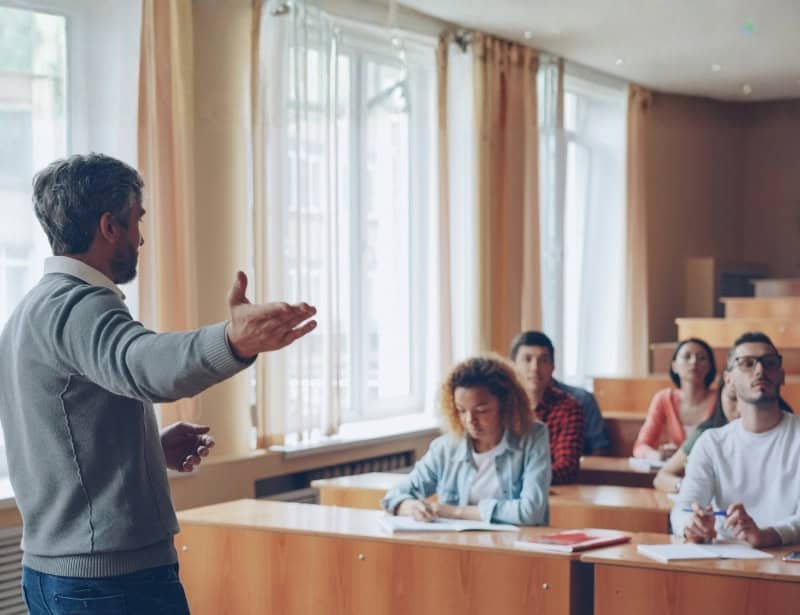 college professor presenting in front of class