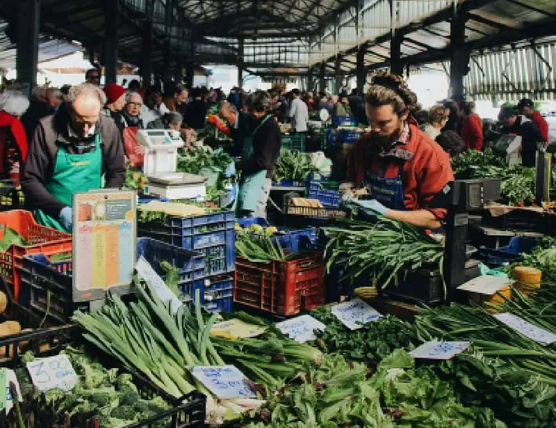 farmers selling vegetables in large market