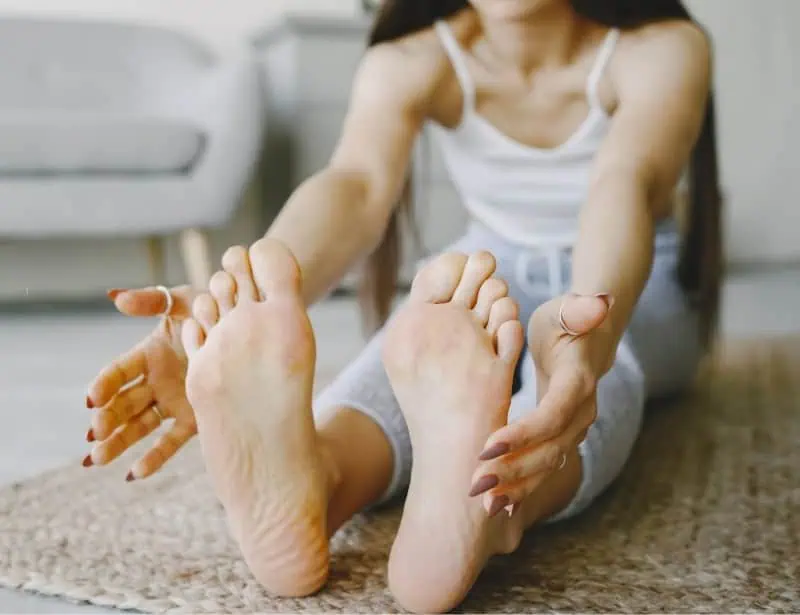 woman stretching legs and feet
