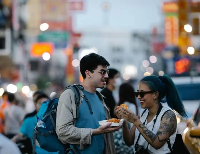 couple tourist eating street food