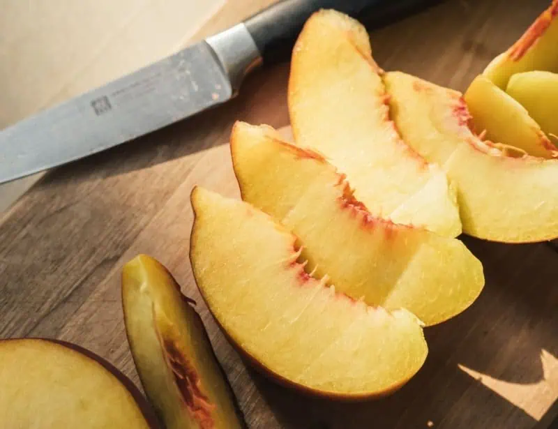 knife and sliced peaches