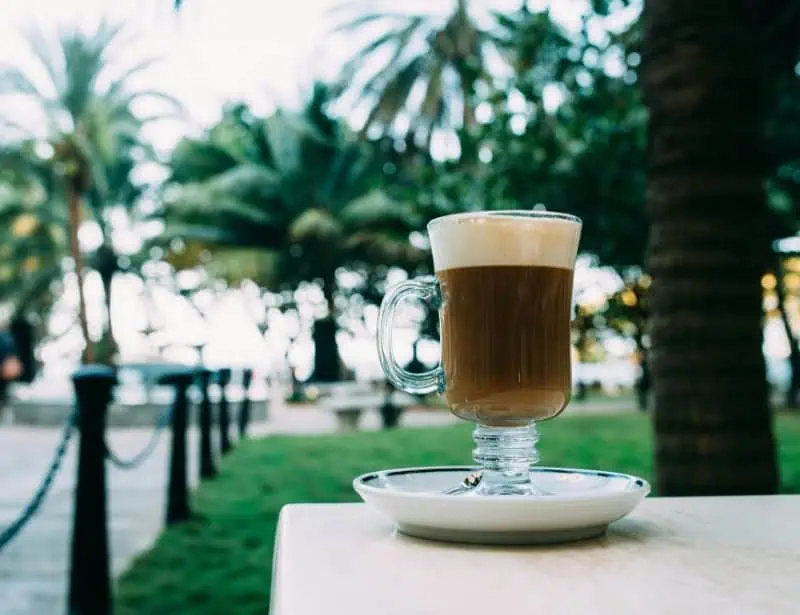coffee with cream top in irish mug on table outdoors