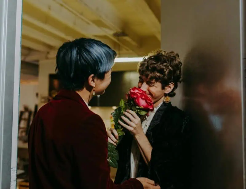 surprising partner with flower at doorstep