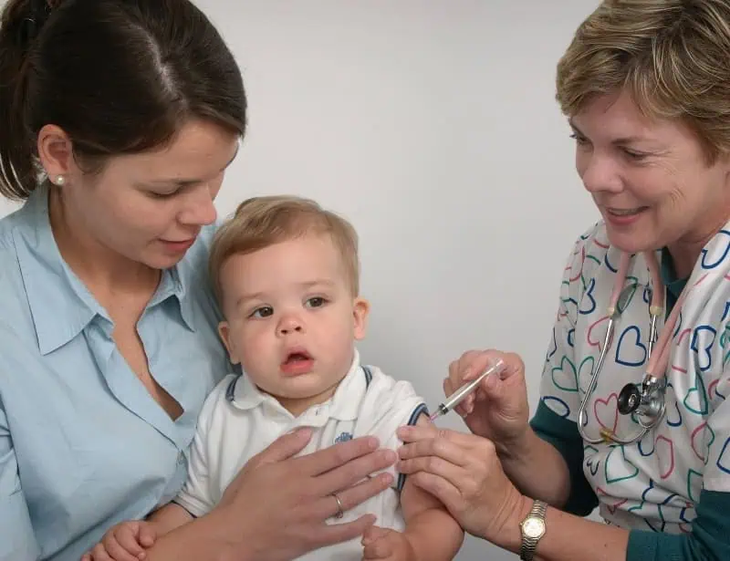 pediatric doctor injecting vaccine to toddler