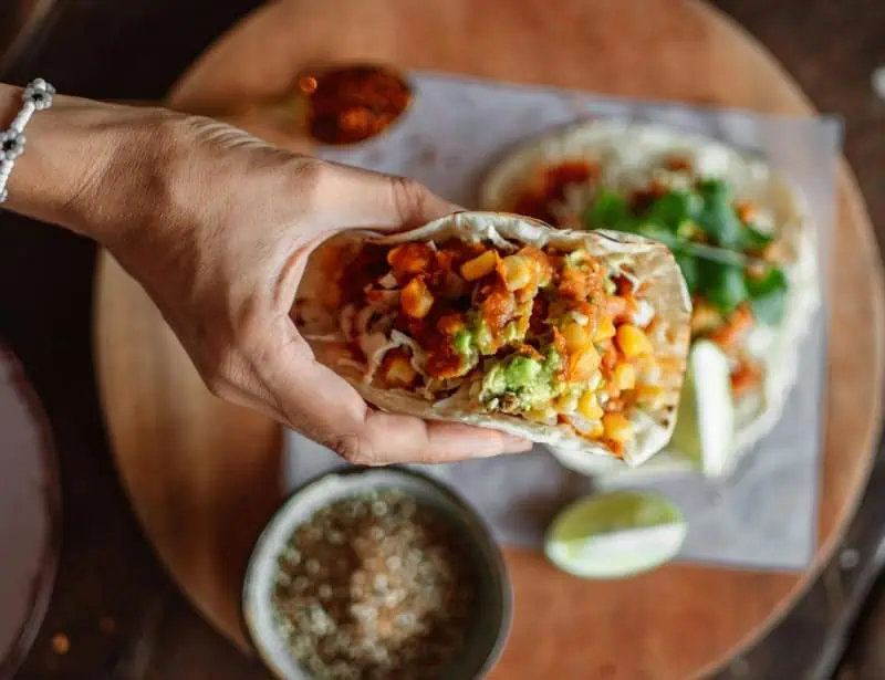 top view of person holding vegan taco