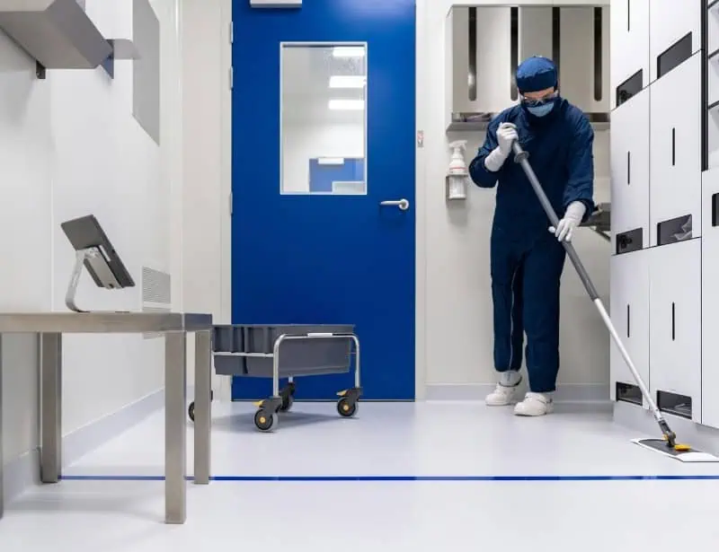 hospital housekeeper mopping the room floor