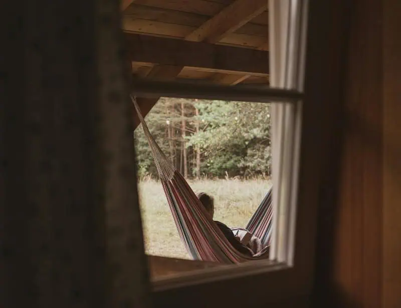 lazy afternoon of person reading book in hammock