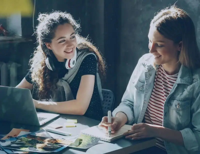 two female workmates smiling
