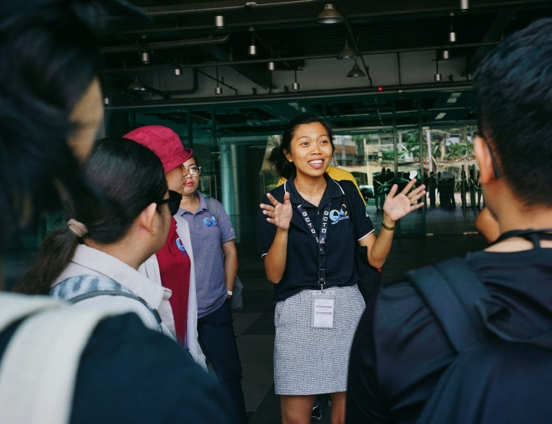 asian tourist enthusiastically explaining during group tour