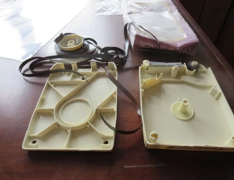 opened beige eight track tape case with removed tape