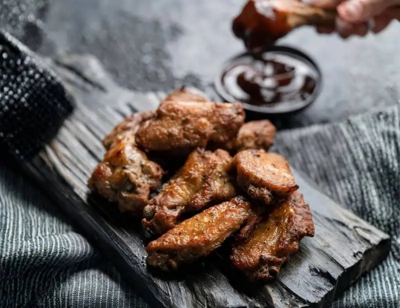 soy glazed chicken wings served on wooden board